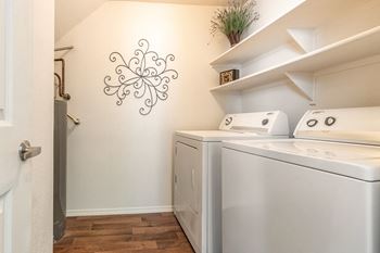 A white wall with a black decoration and a washing machine.